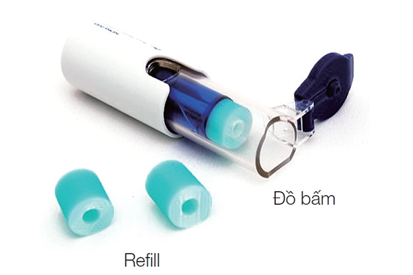 White plastic document hole reinforcement dispenser tool with clear blue inner component alongside light green replacement patch refill rolls